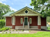Exterior of brick home with white trip and columns