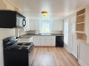 Kitchen with white cabinets and black appliances