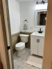 Bathroom with white sink and grey tile