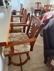 front view of three upholstered and cherry wood barstools