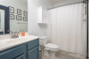 Bathroom with blue cabinets and sho