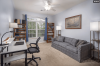 Bedroom being used as a study with couch and desk