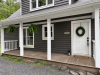 Close view of front of house with front door and large covered porch