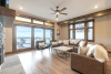 Living area with leather couches and coffee tavle with stone fireplace