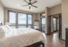 Bedroom with large wood bed frame and long range mountain views
