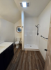 Small bathroom with step in shower