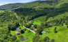 Arial view of house with mountains and trees