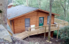 exterior view of log cabin style home with large wood deck