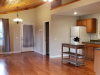 Living area with view of kitchen and hallway