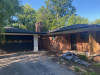 Exterior of home brick with black garage doors