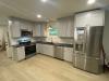 Kitchen with grey cabinets and stainless appliances