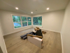 Living room with vinyl plank flooring and a large window