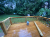Large wooden deck with view of yard