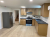 Kitchen with wood cabinets and stainless and black appliances