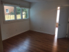 Entrance and living area with hardwood floors