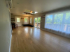 Living area with sliding glass doors and large window.