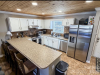 Kitchen with bar and barstools