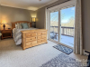 Bedroom with balcone and view furnished with light wood furniture