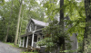 Exterior of grey home with white trim and large front porch