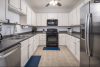 Kitchen with white cabinets and steel appliances