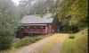 Exterior of home brown wood siding and large porch