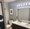Bathroom with double vanity sinks and shower