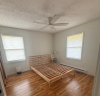 Bedroom with wooden bedframe in a light wood