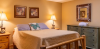 Bedroom with large bed, dresser and nightstand 