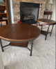 Two round wood and metal tables one large and one small